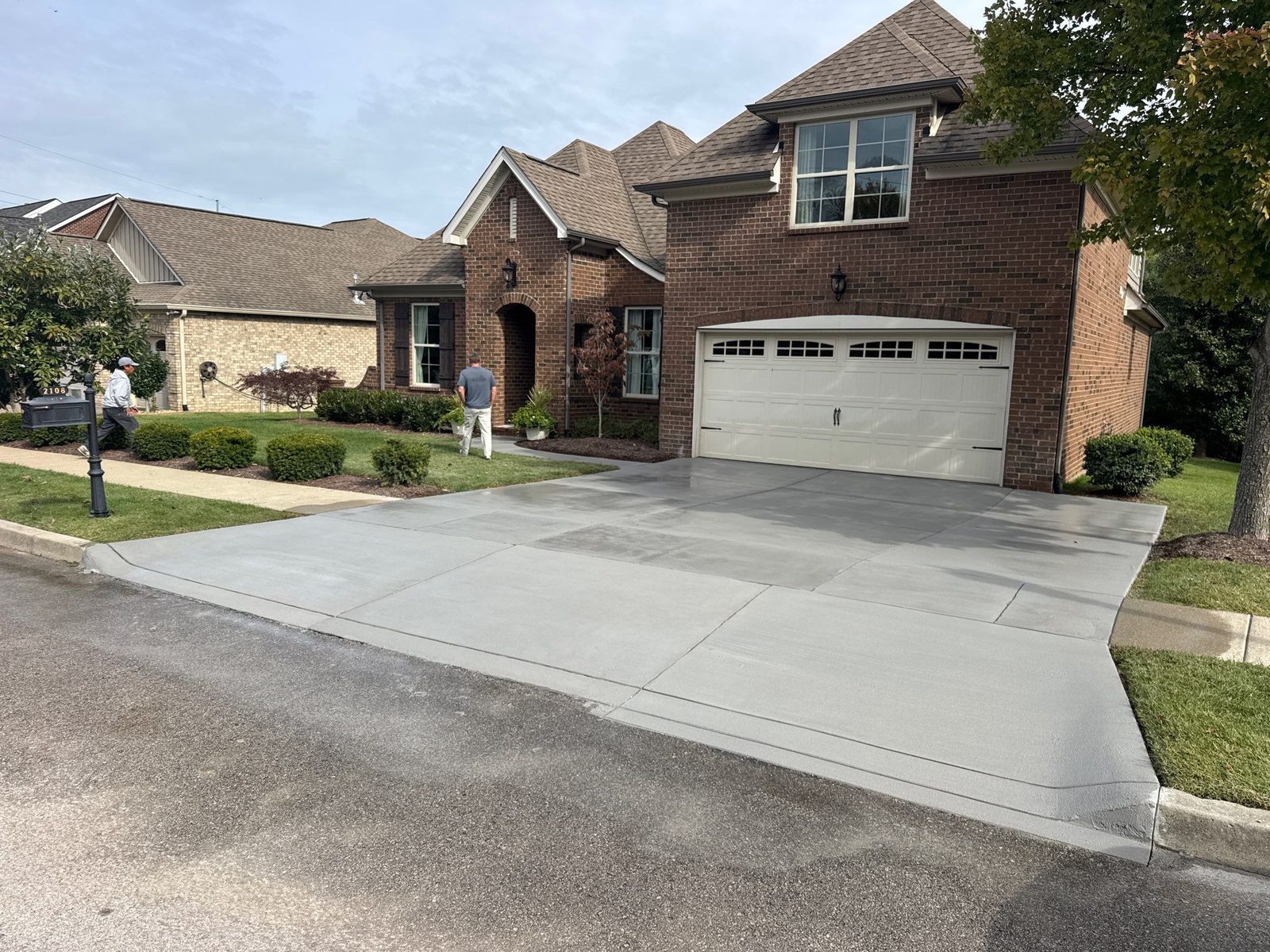 Resurfaced driveway in Westhaven with a clean, even broom finish in front of a brick home