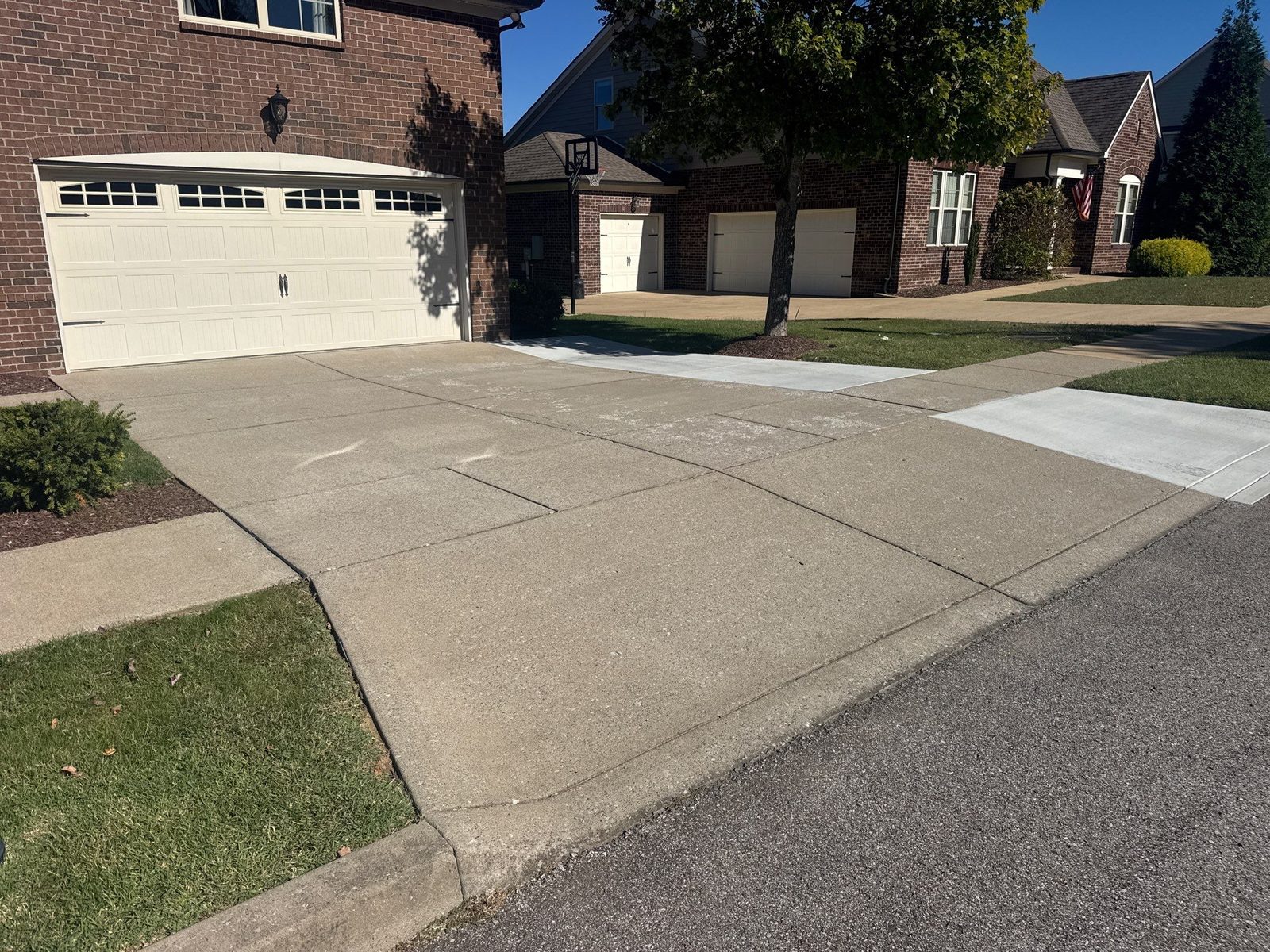 Same Westhaven driveway before resurfacing, worn and stained gray concrete