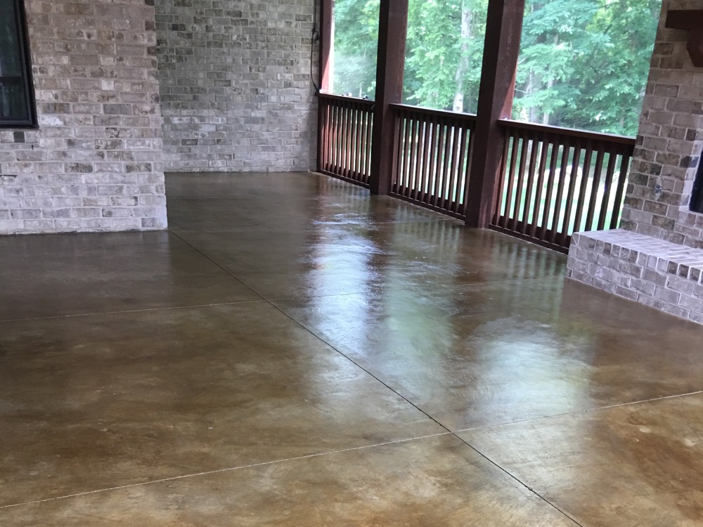Screened porch in Williamson County with a warm variegated brown stained and sealed concrete floor